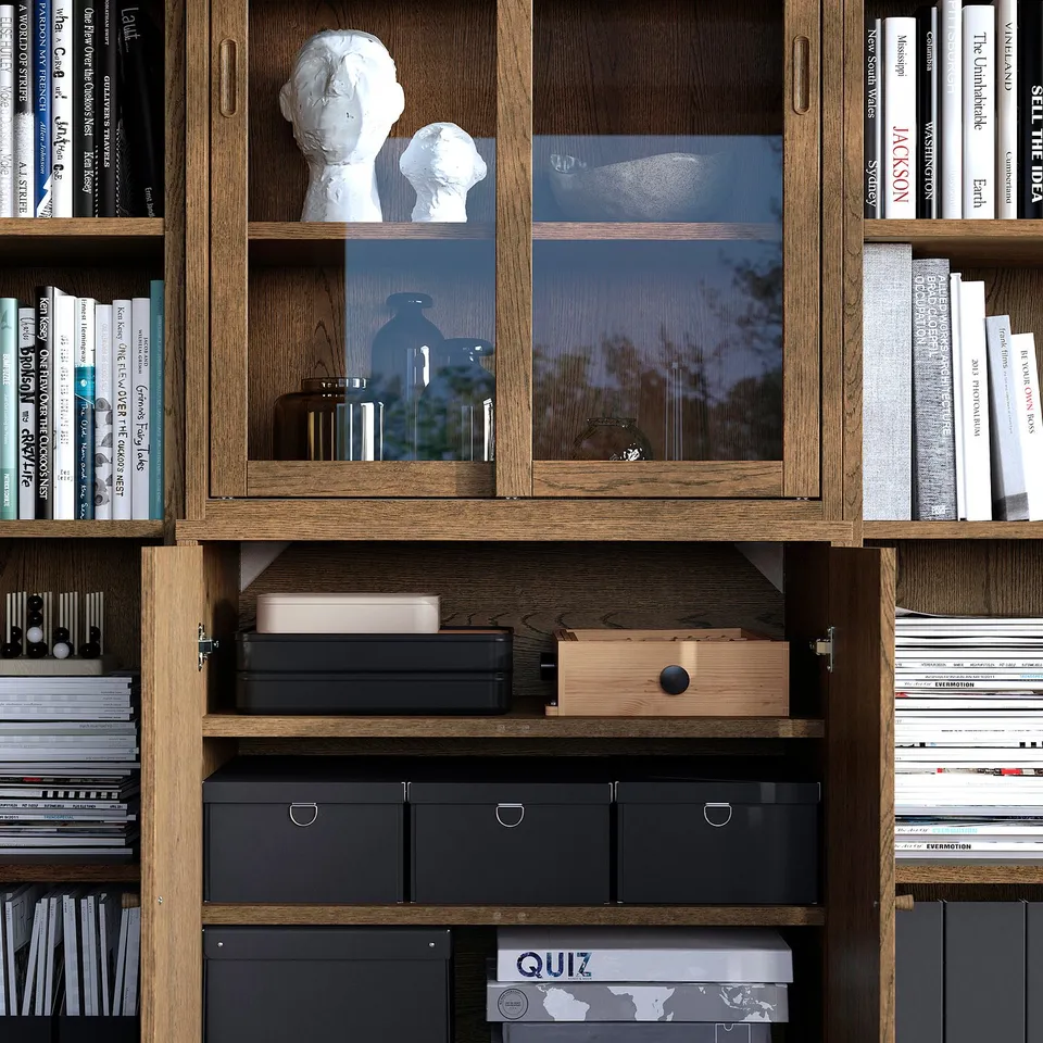 Bookshelf with glass doors showing decorative items and books, featuring open storage compartments below.
