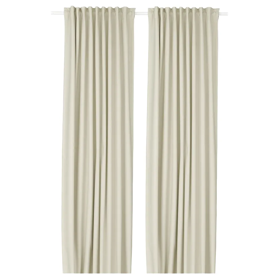 Two beige KORGMOTT block-out curtains with rod pockets, designed to block light and provide privacy.