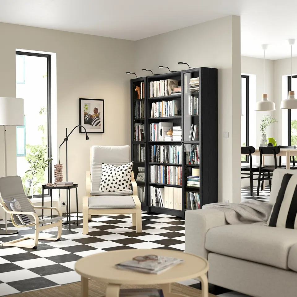 Cosy living room with BILLY bookcase, chairs, & light-filled window.