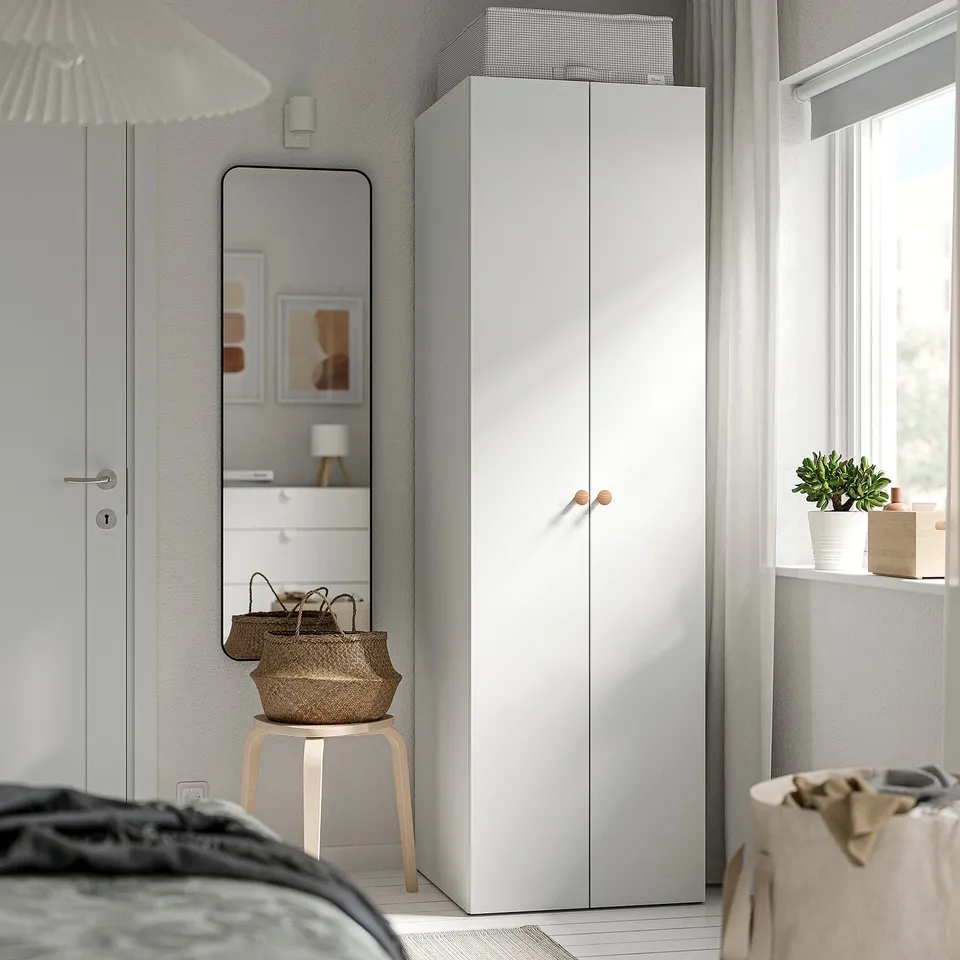 Modern bedroom with white LASTARE wardrobe, minimalist design, and other white furnishings.