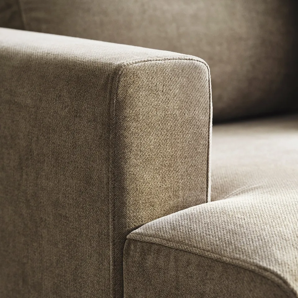A close-up of the UPPÅKRA sofas armrest, highlighting its high-quality, textured fabric and sleek design.