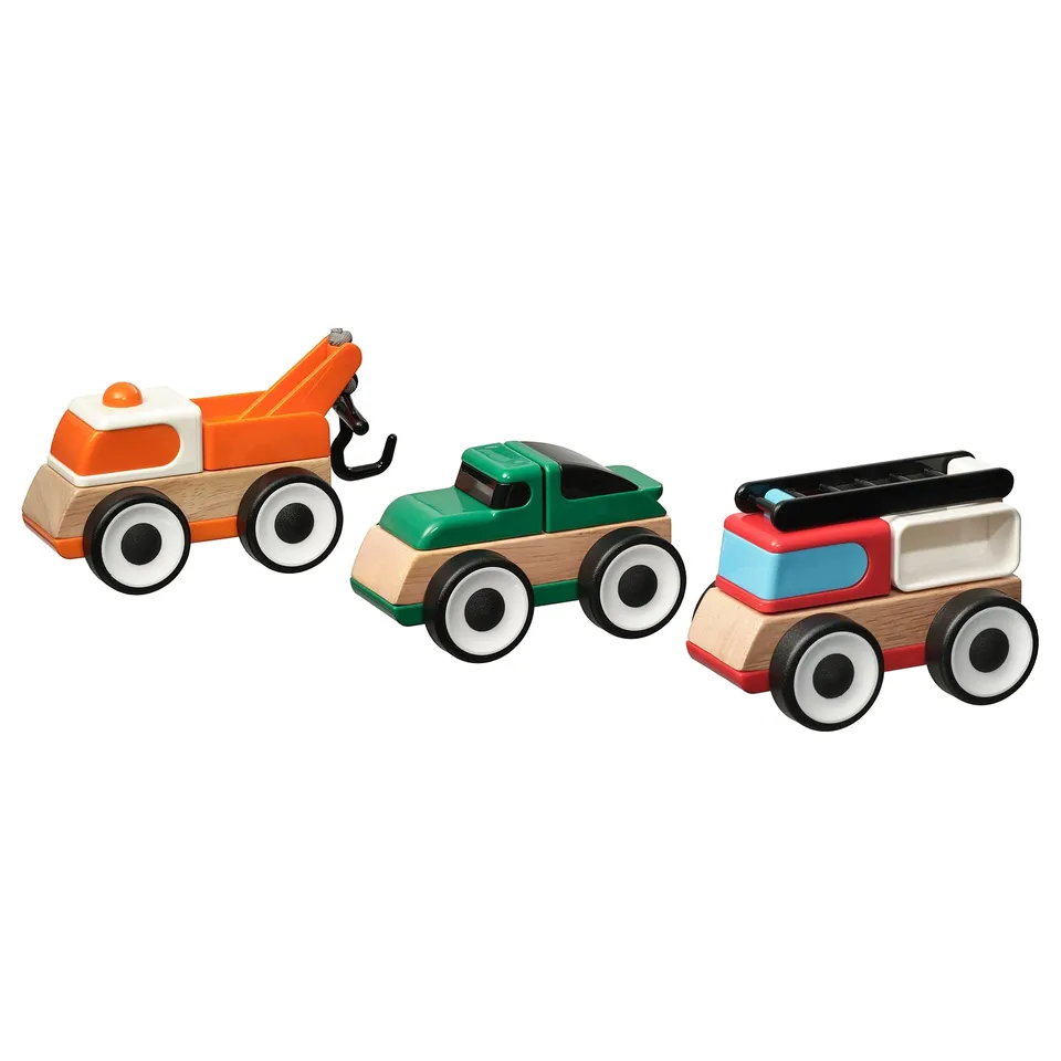 Three wooden toy vehicles in orange, green, and red with black, white, and blue accents, each with four wheels.
