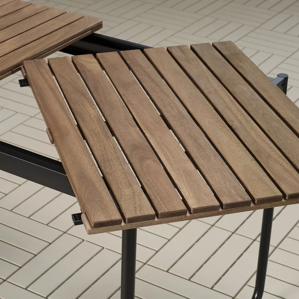 Wooden outdoor table with metal legs, featuring a slatted, natural-finished top, designed for durability and ease of use.