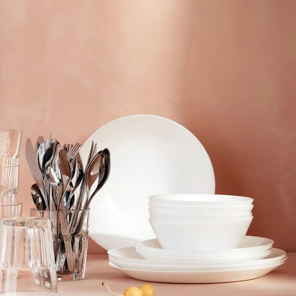 OFTAST white glassware set: plates, bowls, and utensils. Elegant, stackable, dishwasher-safe.