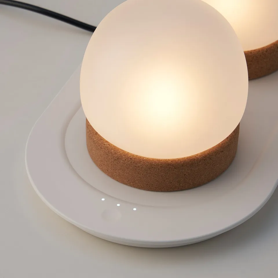 Close-up of a glass and cork table lamp, part of a trio, showcasing its high-quality, minimalist design.