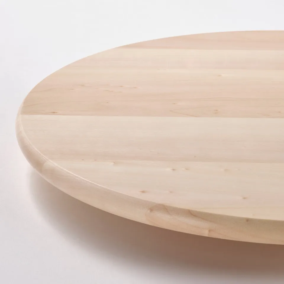 Light wooden tray with smooth surface. Round and polished, showing fine grain texture.