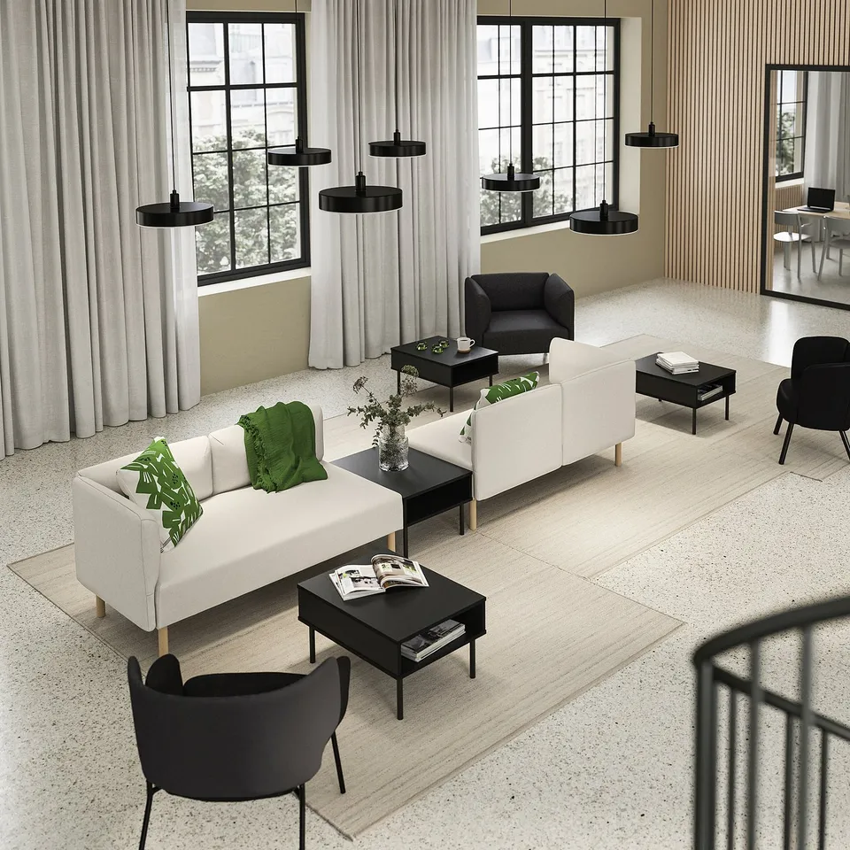 Modern living room with white LILLEHEM sofa, black chairs, coffee tables, and pendant lights. Large windows with curtains.