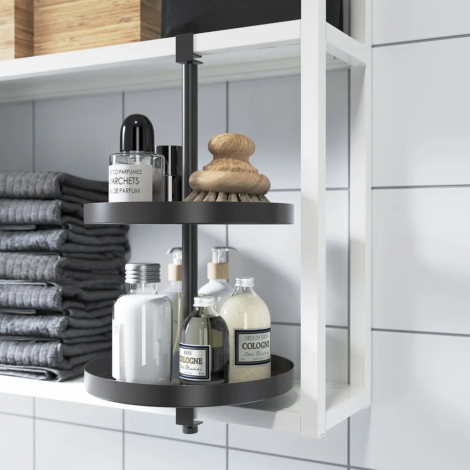 A swivel shelf in a bathroom, holding toiletries and towels. The shelf turns to easily access items.