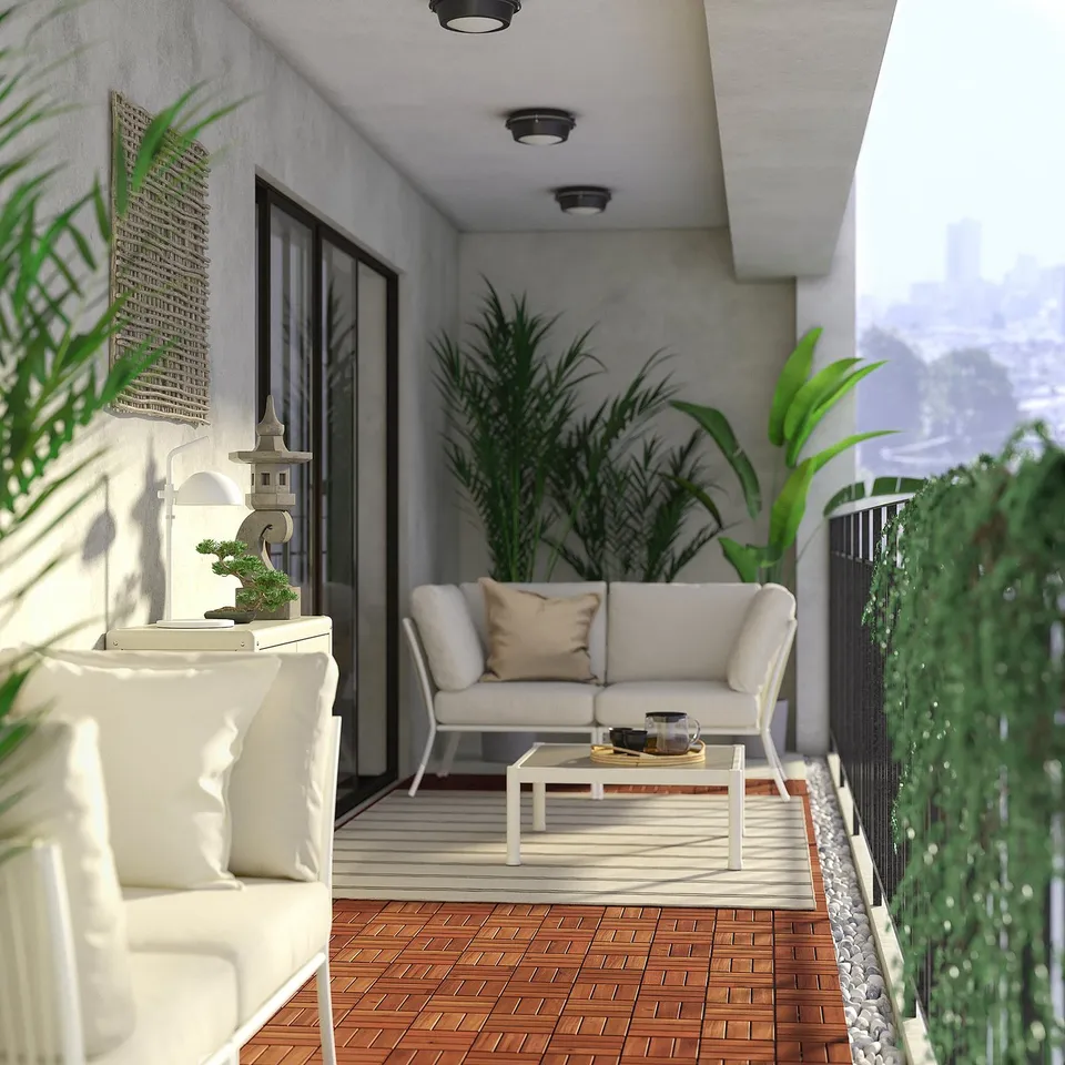 Modern balcony with light beige SEGERÖN sofa, white coffee table, lush plants, wooden floor tiles, and sliding glass door.