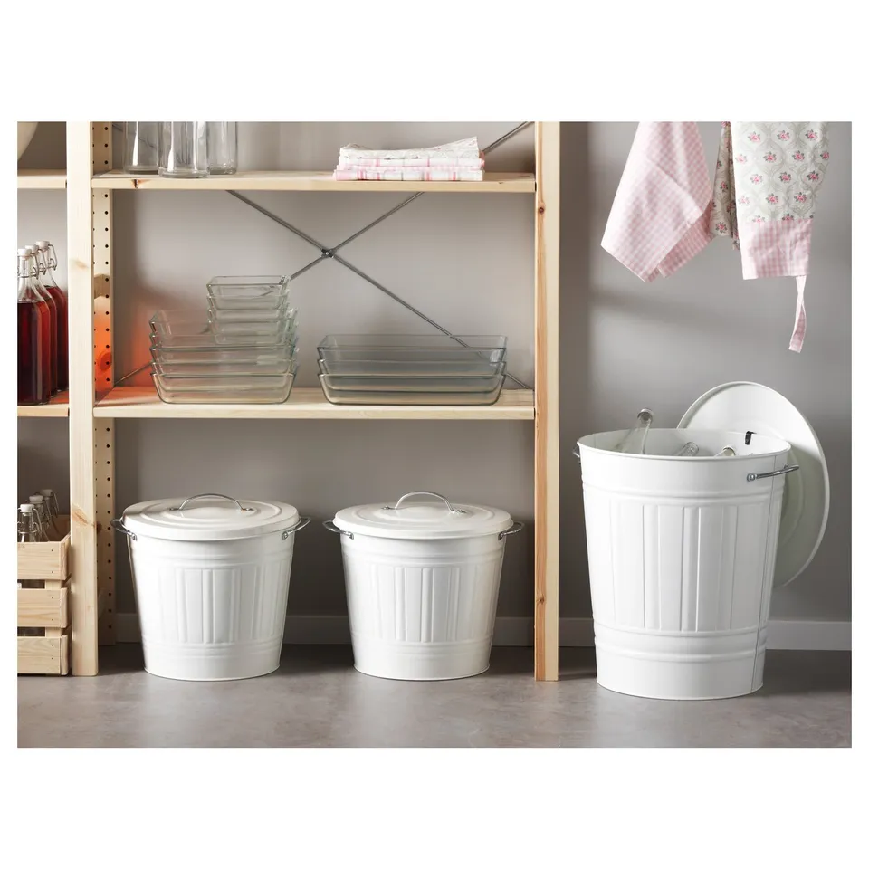 Three white bins with lids on shelves. One slightly open, sturdy with handles and hooks.