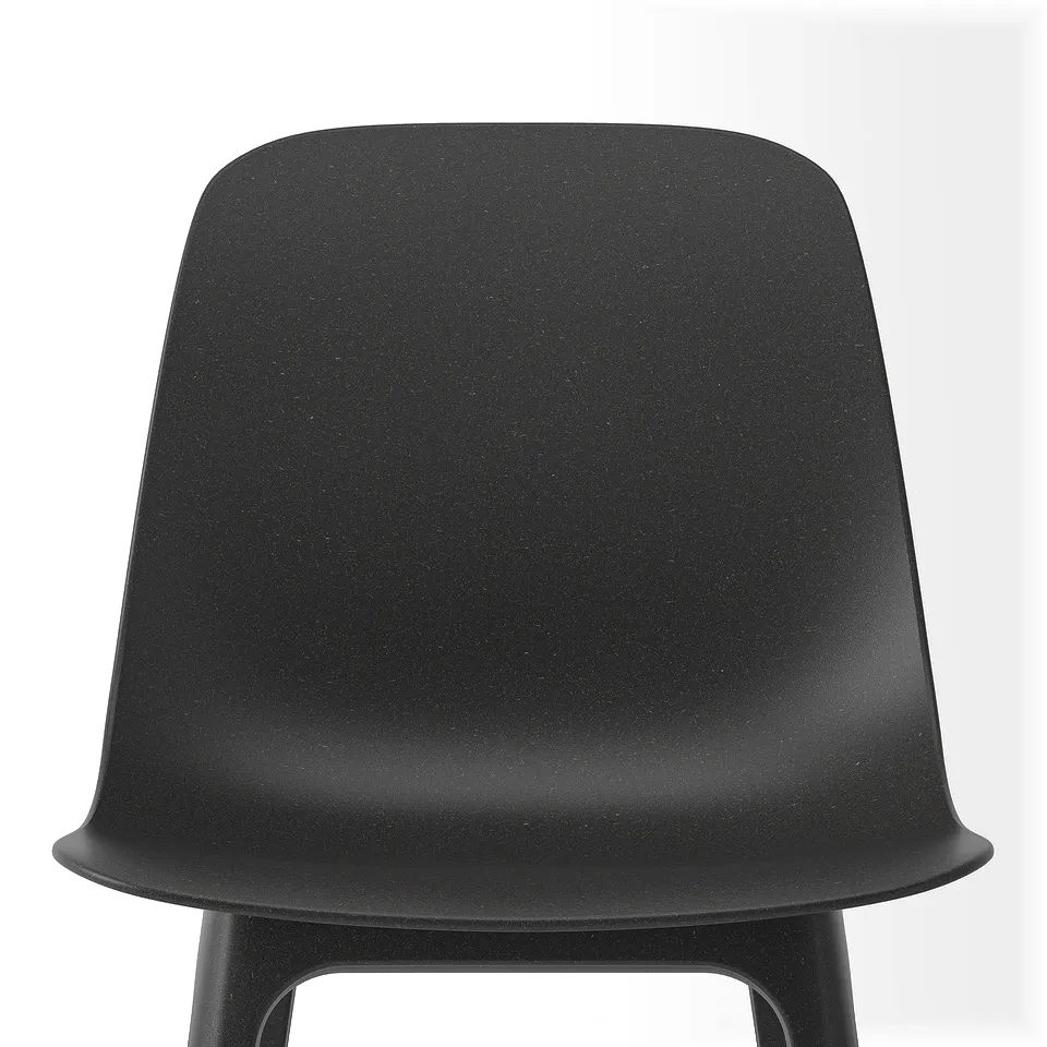 Modern black chair with ergonomic design, textured surface, ready for quick assembly.