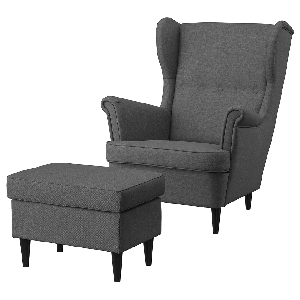 Dark grey STRANDMON wing chair with matching footstool, upholstered in recycled polyester.