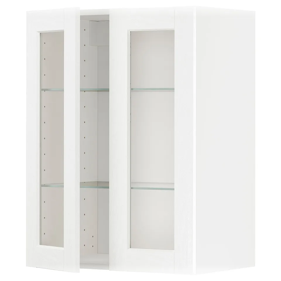 A white ikea METOD kitchen cabinet with glass doors and shelves.