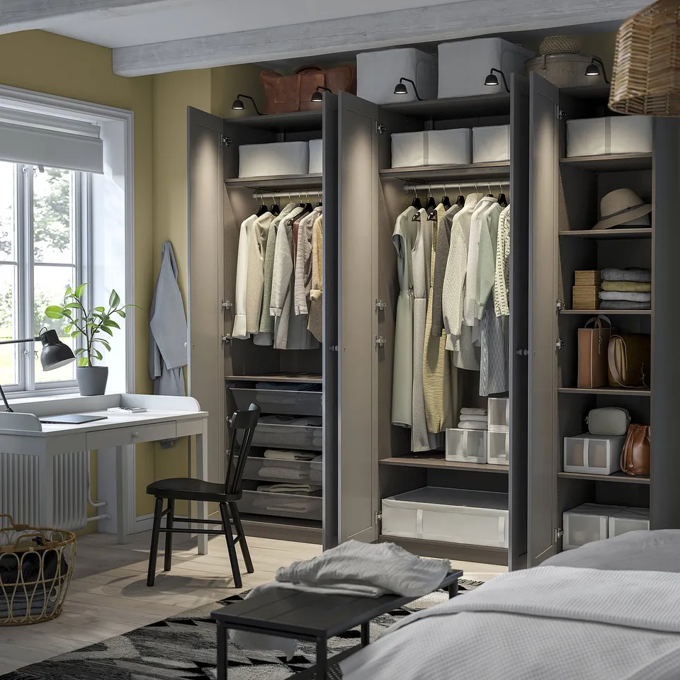 Open wardrobe with folded clothes, shelves, and hanging garments, showing organised storage in a multilevel closet system.