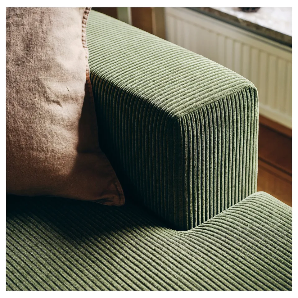 Close-up of green corduroy sofa, soft texture, modern design, cosy corner.