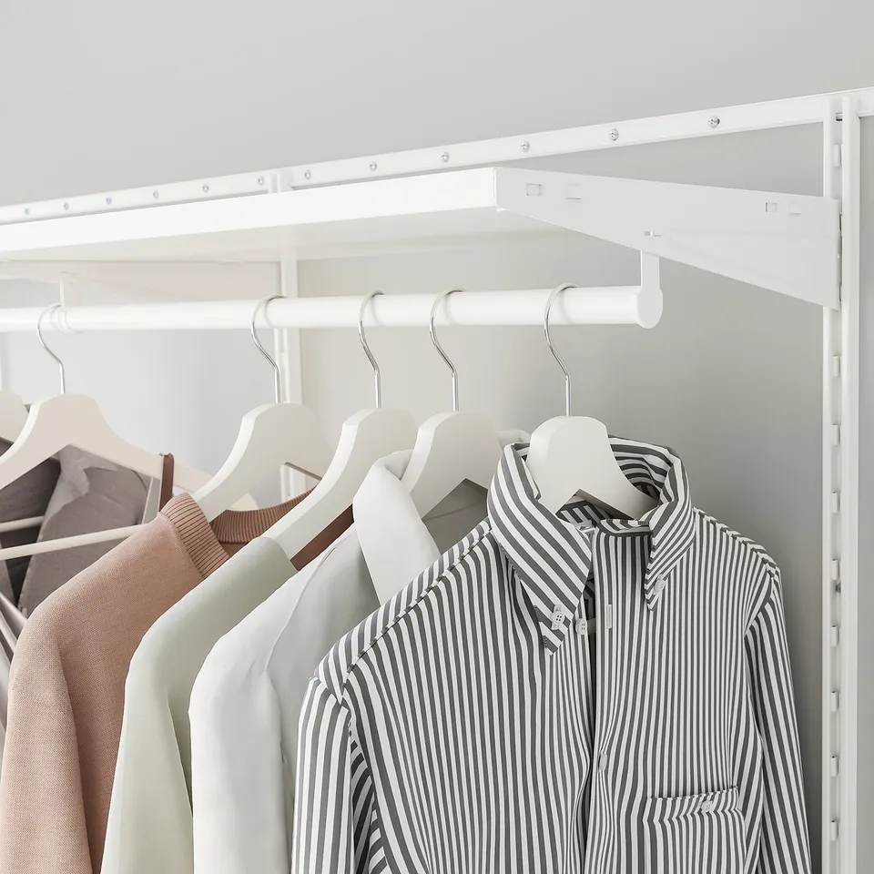 A white BOAXEL closet with striped shirt prominently displayed, neatly organising shirts efficiently in limited space. Char count: 149