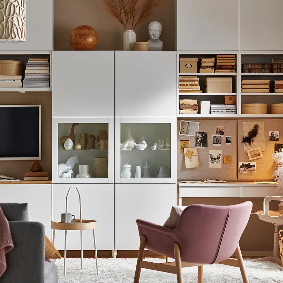Modern living space with BESTÅ storage, white/light wood, glass, and shelves displaying tv, books, and decor.
