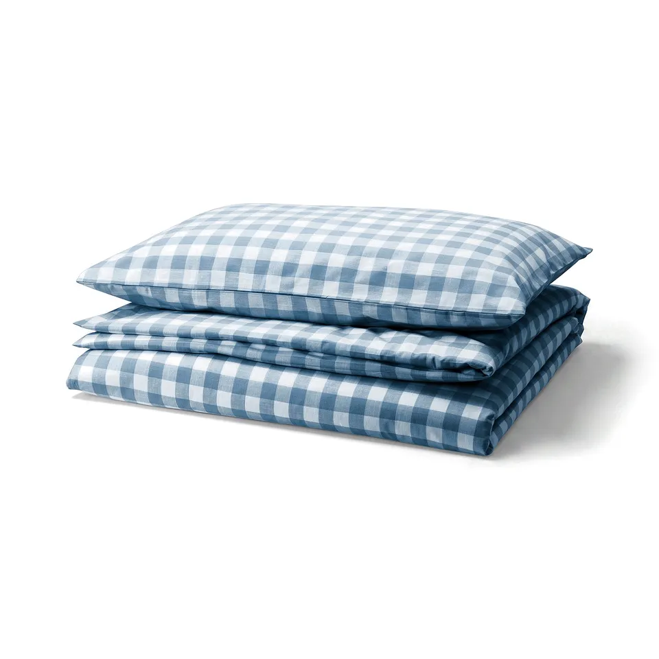 Solid blue and white chequered bedding set, folded neatly. Made of 100% organic cotton.