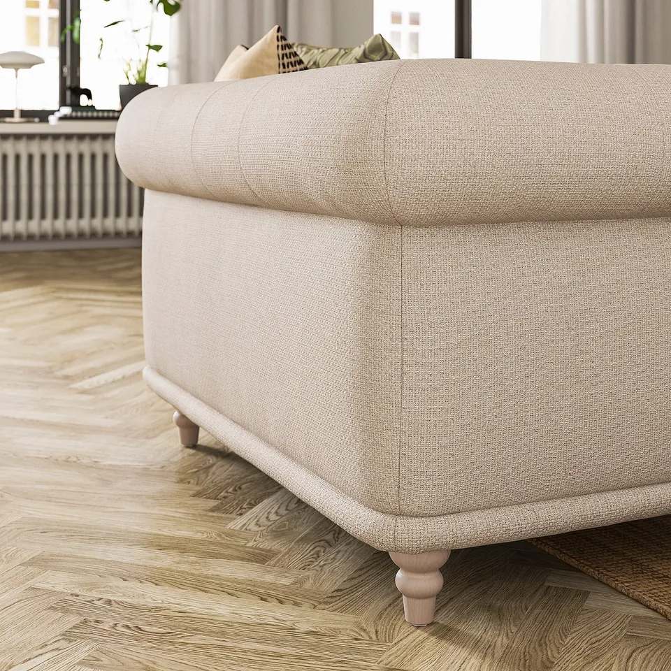 Beige VISKAFORS sofa, classic design, soft rounded shapes, wooden legs.