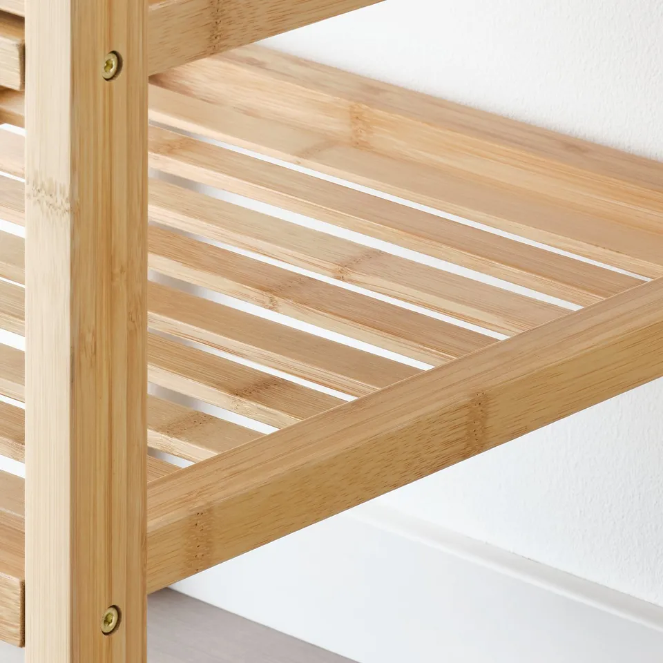 Bamboo storage drawer seen from angle, craftsmanship shown in slats and golden screws.