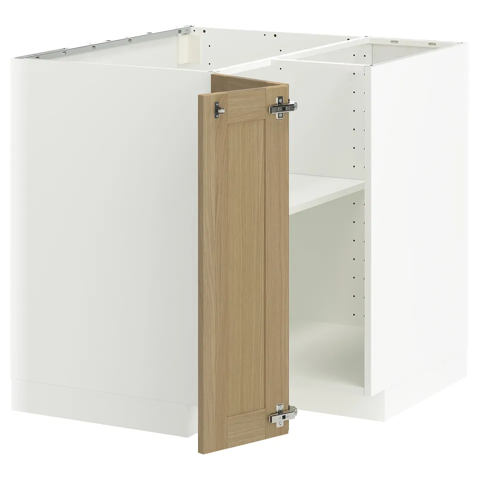 A white METOD kitchen unit with oak doors partially open, revealing shelves inside.