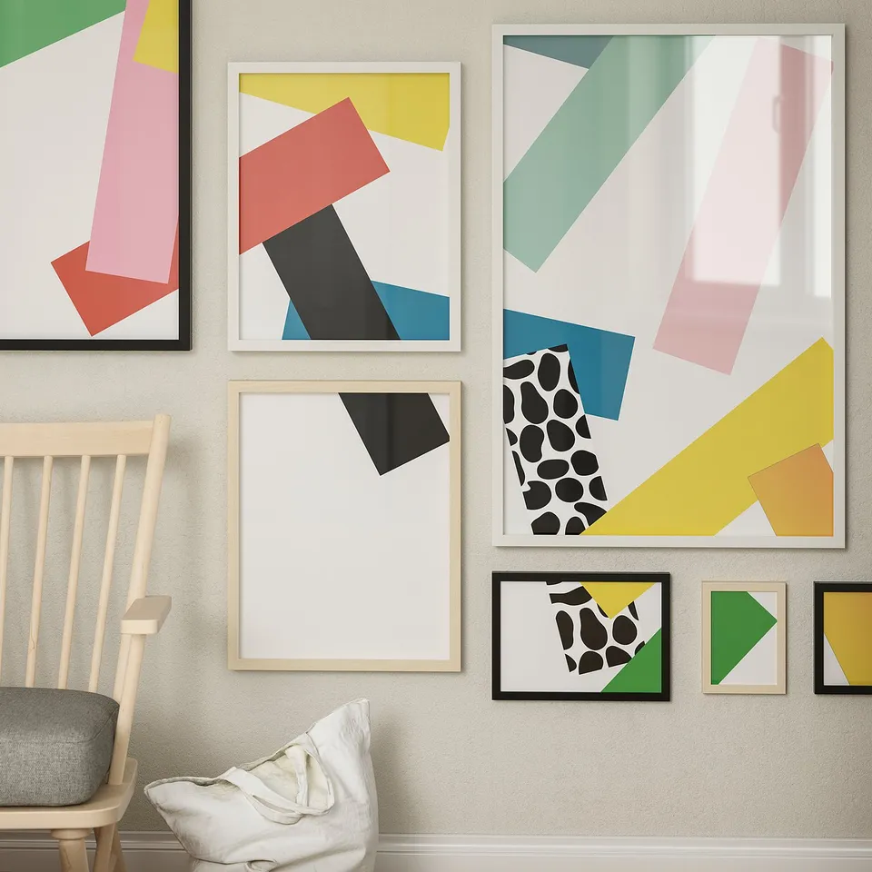 Colourful geometric prints in modern frames adorn a wall, with a vibrant chair in front.