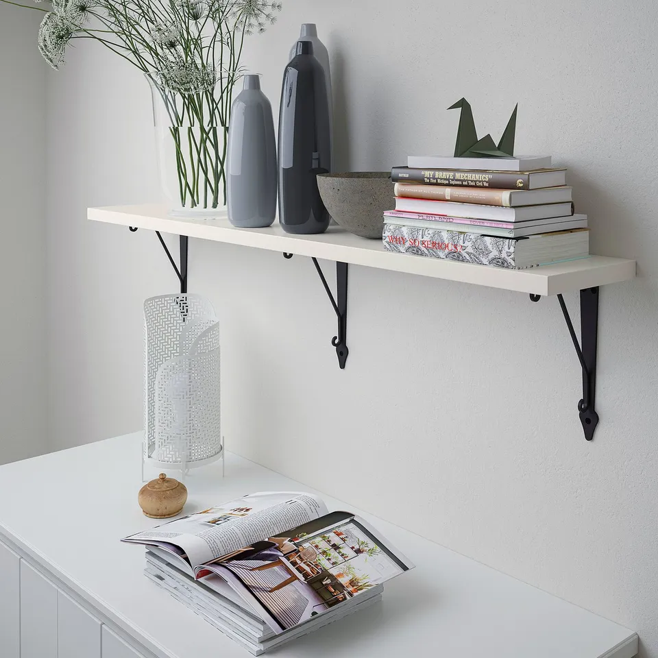 Realistic a white wall shelf with two vases, a stack of books, and a cylinder light.