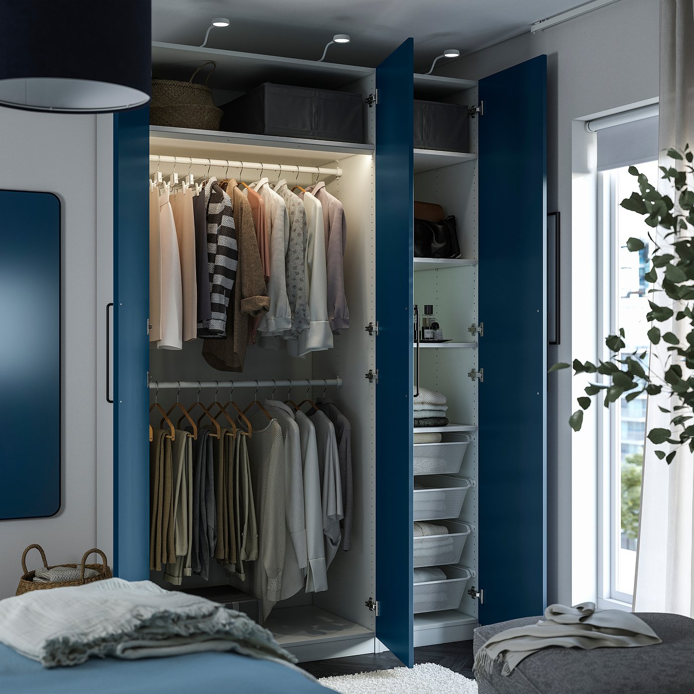 A modern closet with blue doors open, revealing hanging clothes, shelves, and baskets, designed to maximise storage space.