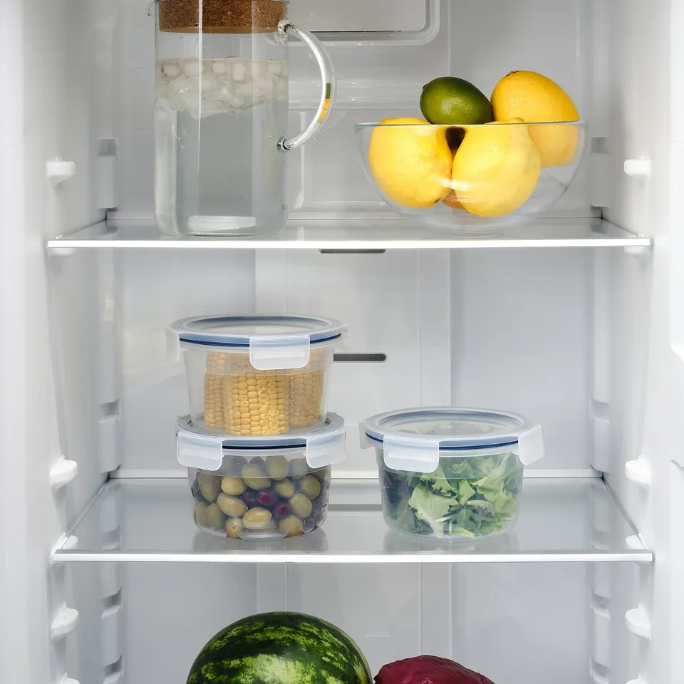 IKEA 365+ containers stackable, storing various foods: lemons, corn, olives, lettuce.