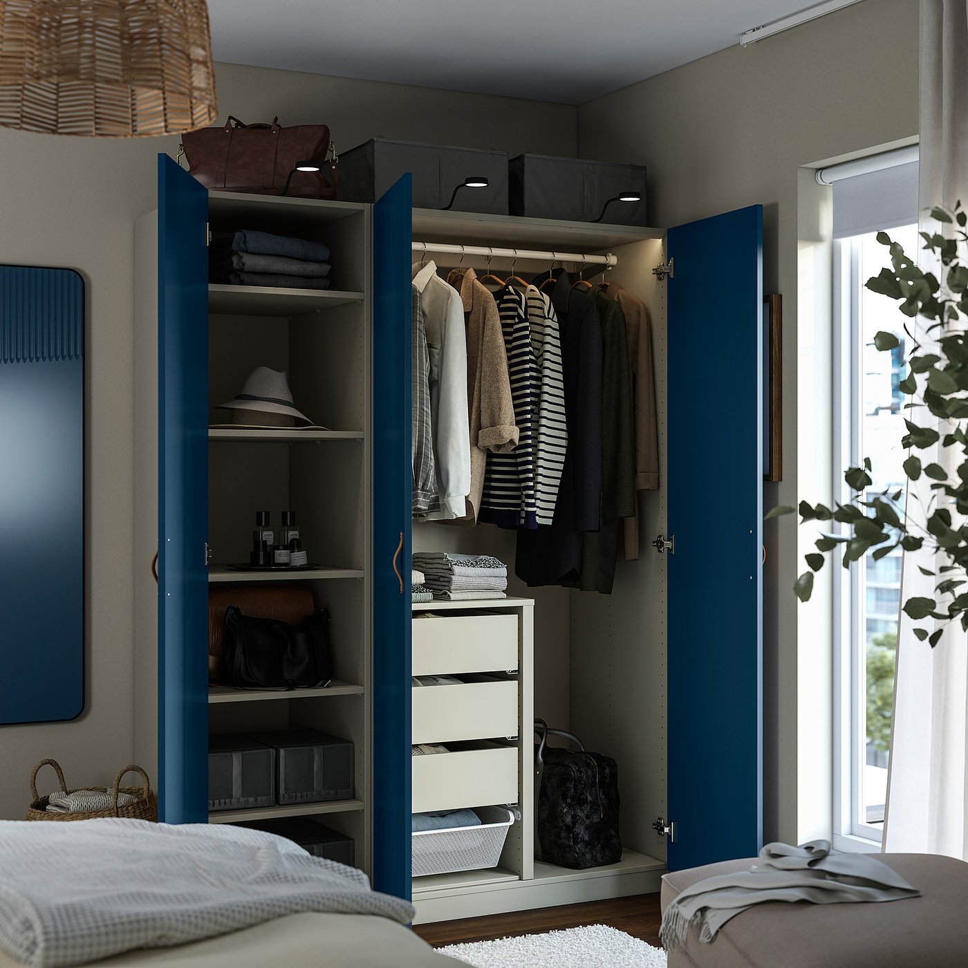 Open blue wardrobe with clothes, bags, and folded items on shelves and drawers. Integrated lighting at top.