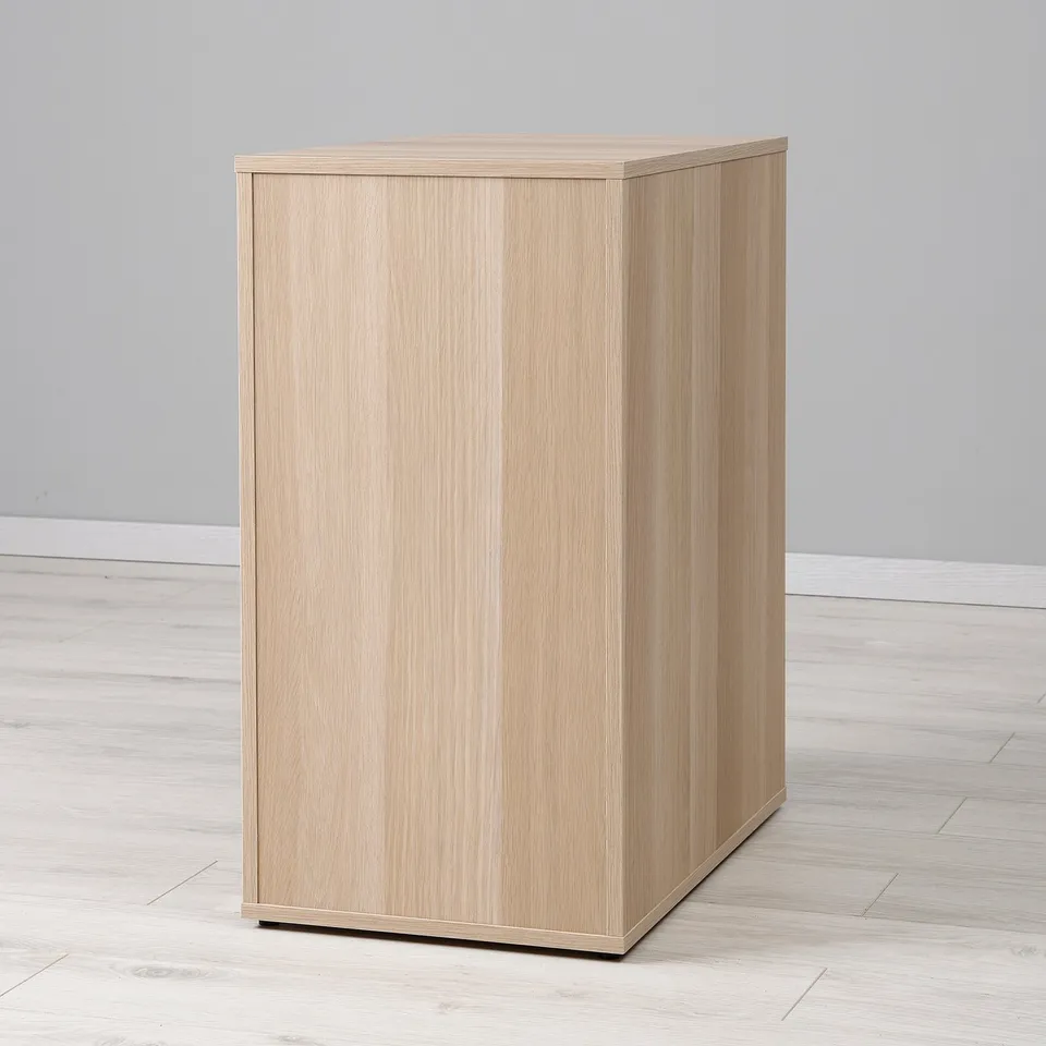 Light wood cabinet, well-made, standing on light floor, minimalist design.
