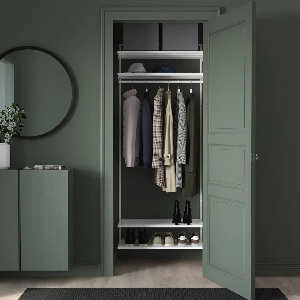 Wall-mounted closet with open storage, organised sections, green frames.