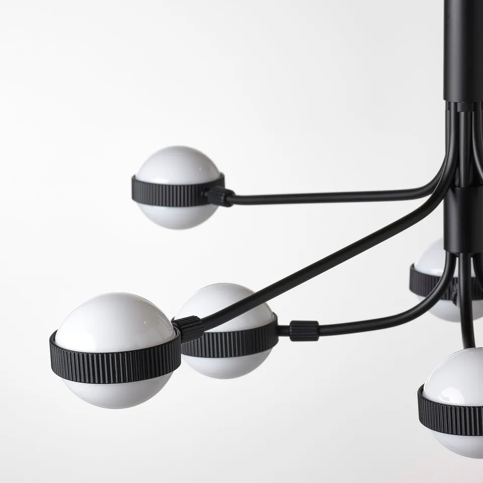 Modern chandelier with 8 spherical led lights, black arms and base, elegant and minimalist design.