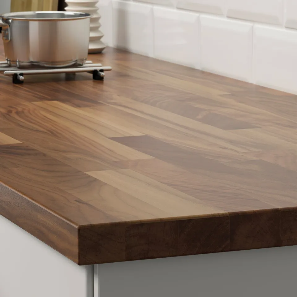 A wooden kitchen countertop made of walnut veneer, showing its durable, natural finish and sturdy construction.