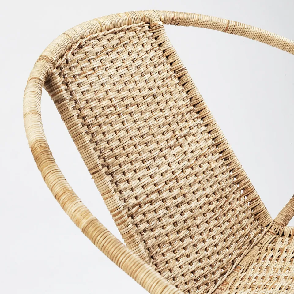 Woven rattan chair, finely detailed, sturdy build.