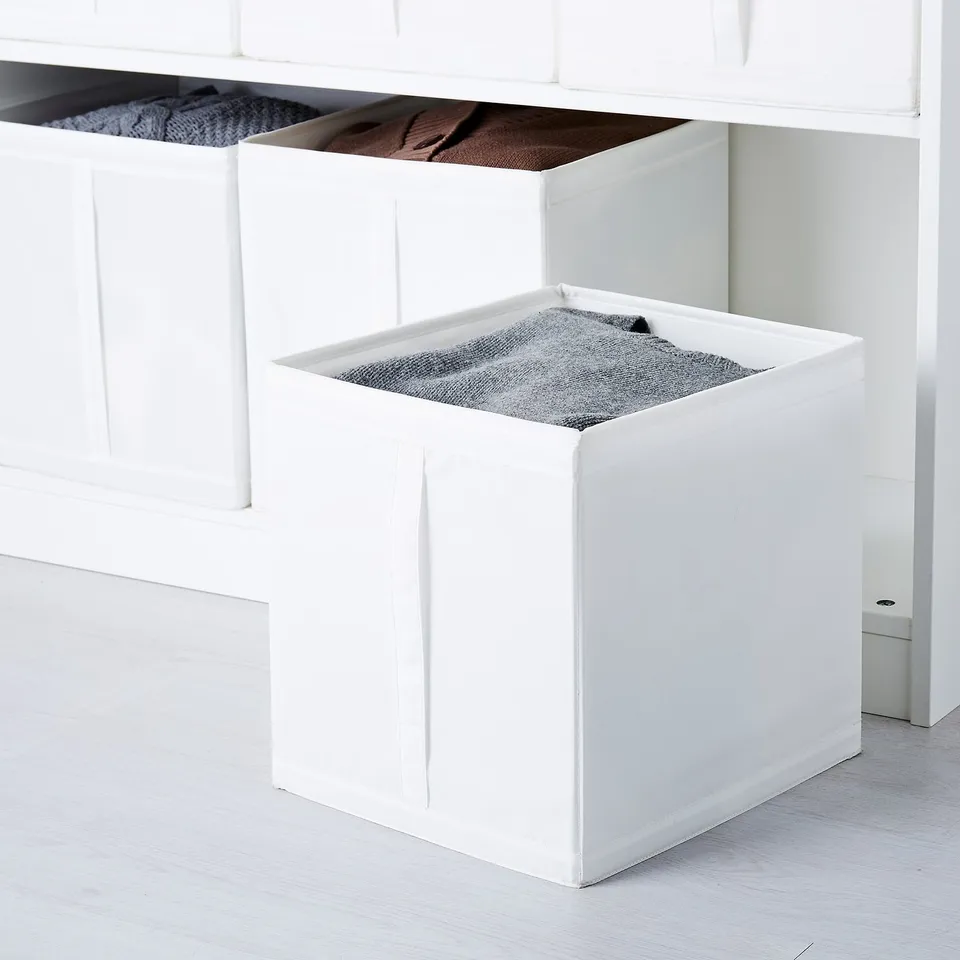 White storage boxes for organising socks, clothes, and sweaters in a wardrobe; handles for easy access, folds flat for space-saving.