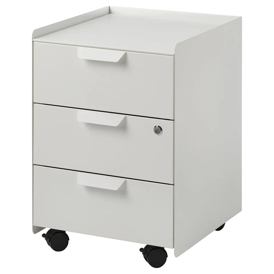 A white TROTTEN storage cabinet with three drawers and black casters, designed for easy mobility and secure storage.