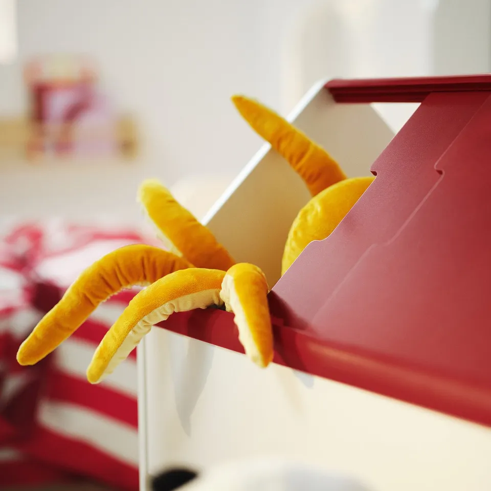 VITBJÖRN child storage unit, red with curved yellow handles, standing upright.