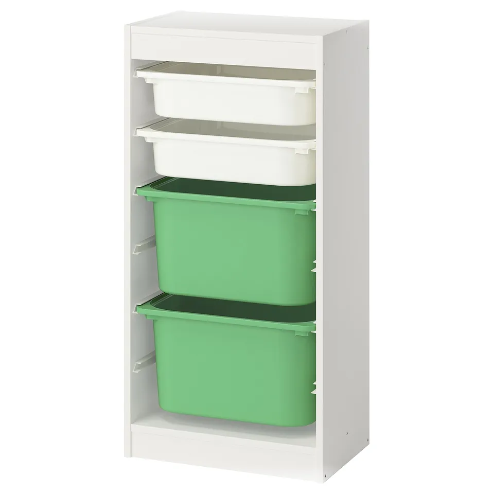 A TROFAST kids storage unit with white frame, green plastic boxes, and clear plastic trays. It has a modern, organised design.