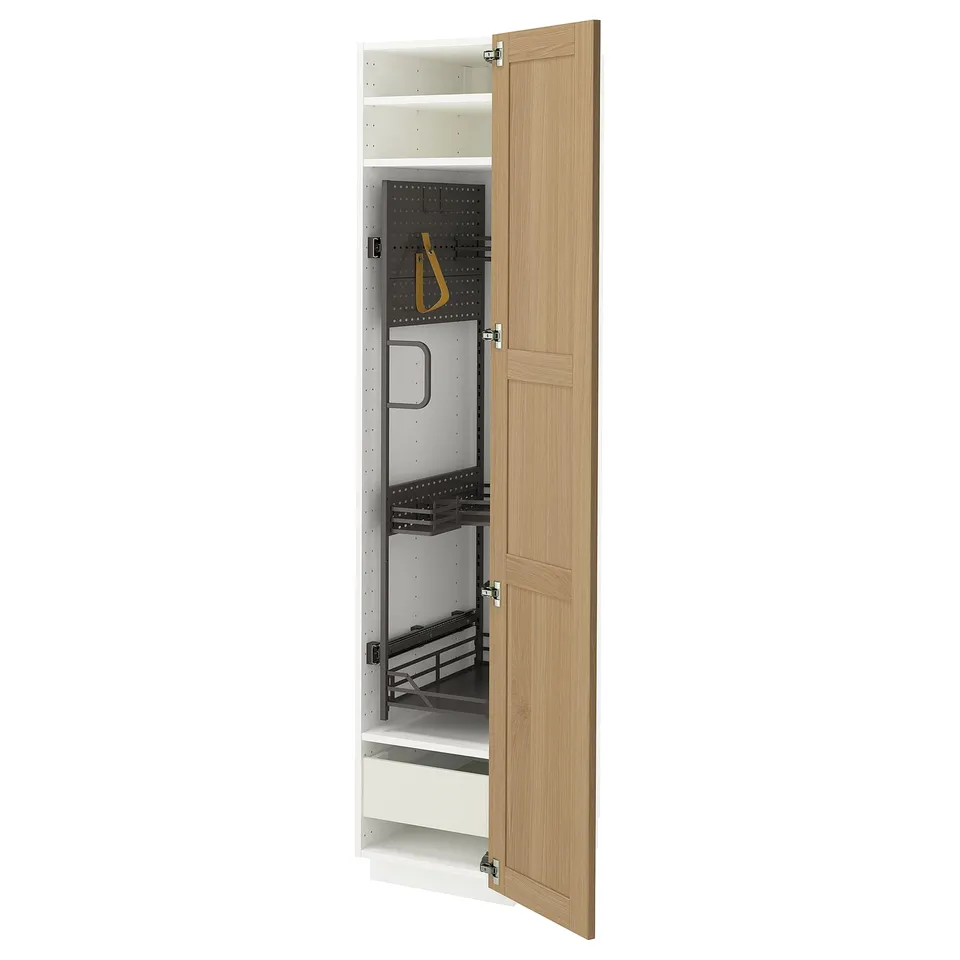 Open oak wooden kitchen cabinet with metal organisers on white background.