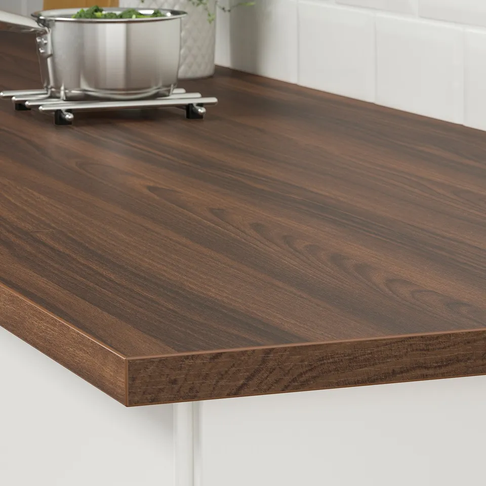 Dark wood countertop with straight edge, supporting metal legs. Ideal for kitchens, easy to clean.