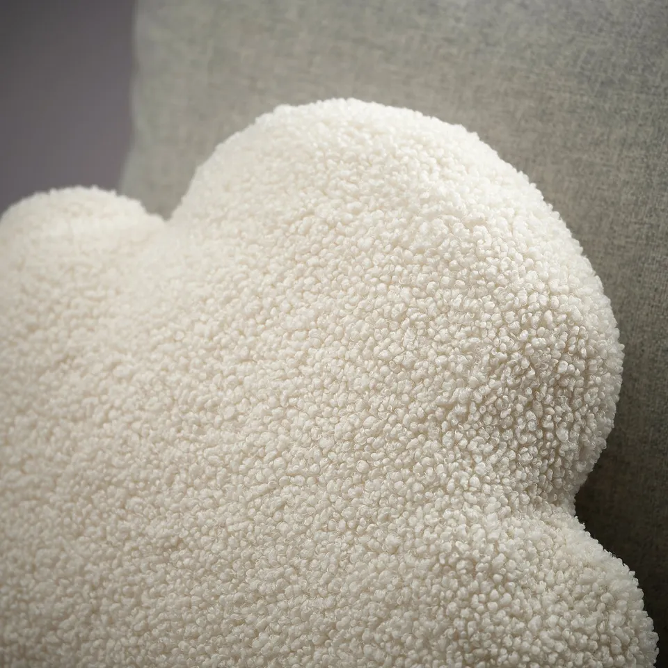 Fluffy cloud-shaped cushion, soft and inviting, made from recycled polyester, offering comfort and support.