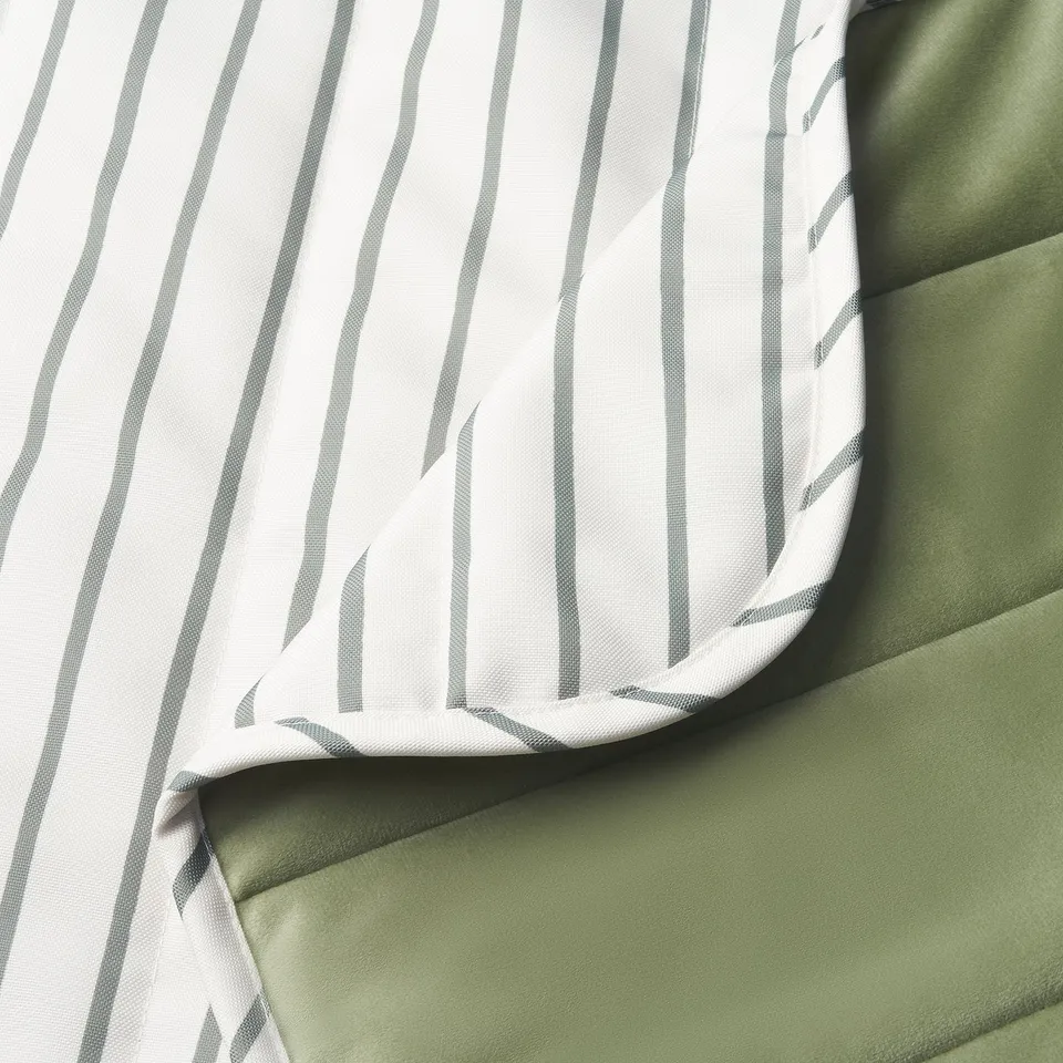 Close-up of durable, striped fabric over slumped green material, showcasing quality and texture.
