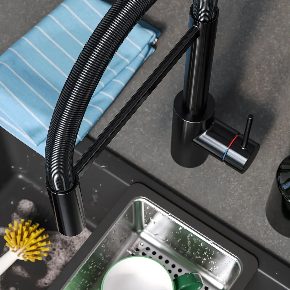 Modern kitchen tap with high-arc gooseneck and pull-down sprayer, featuring sleek design and dual-spray functionality, set against dark countertop.