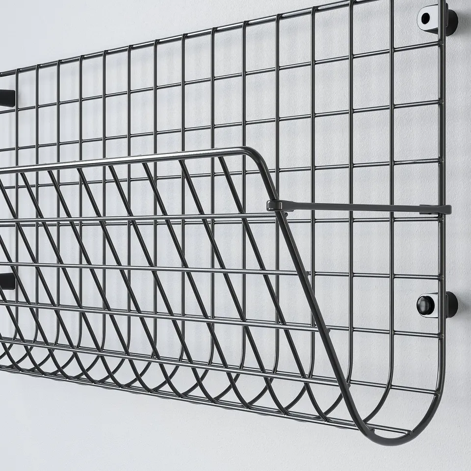 Metal wall-mounted shoe rack with angles and hooks for storage.