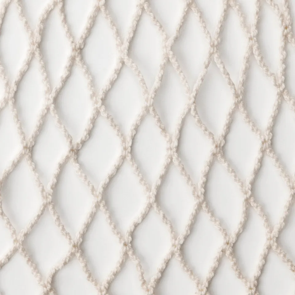 Clean white cotton net bag, finely woven with diamond patterns, ideal for fruit storage.