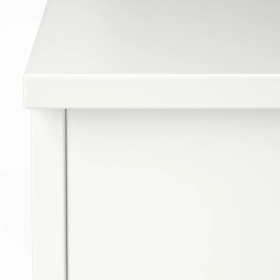 Crisp white coffee table detail. Smooth edges, clean lines.