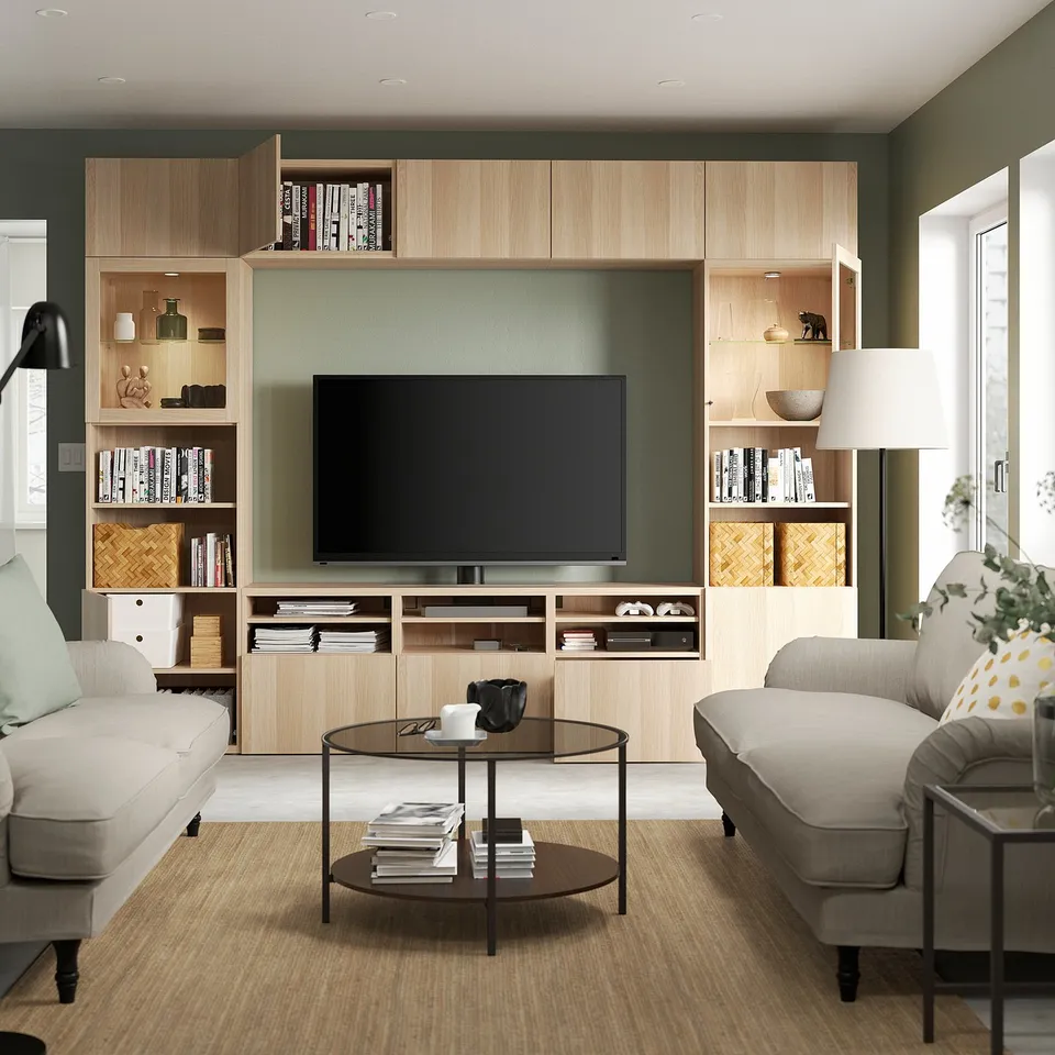 Modern living room with tv unit, adjustable shelves, and grey sofas flanking a glass coffee table with magazines.