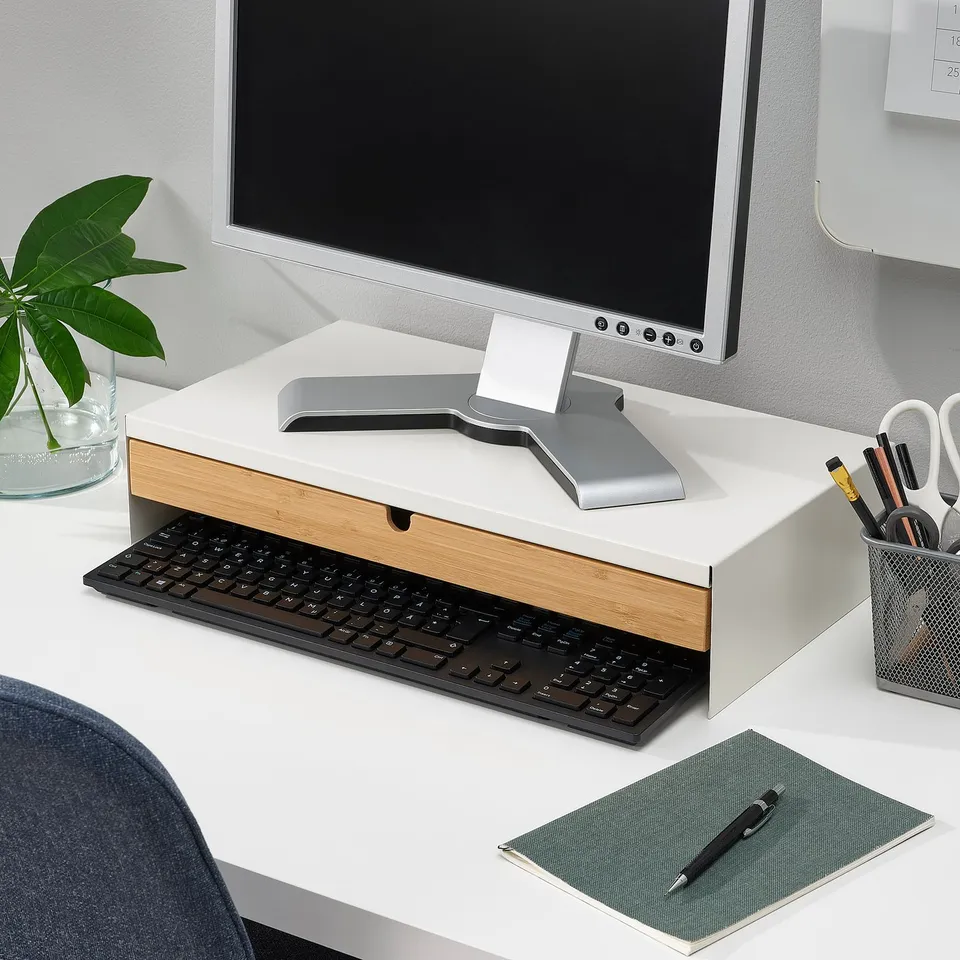 ELLOVEN silver+bamboo monitor stand with storage, plant, scissors, and notebook.