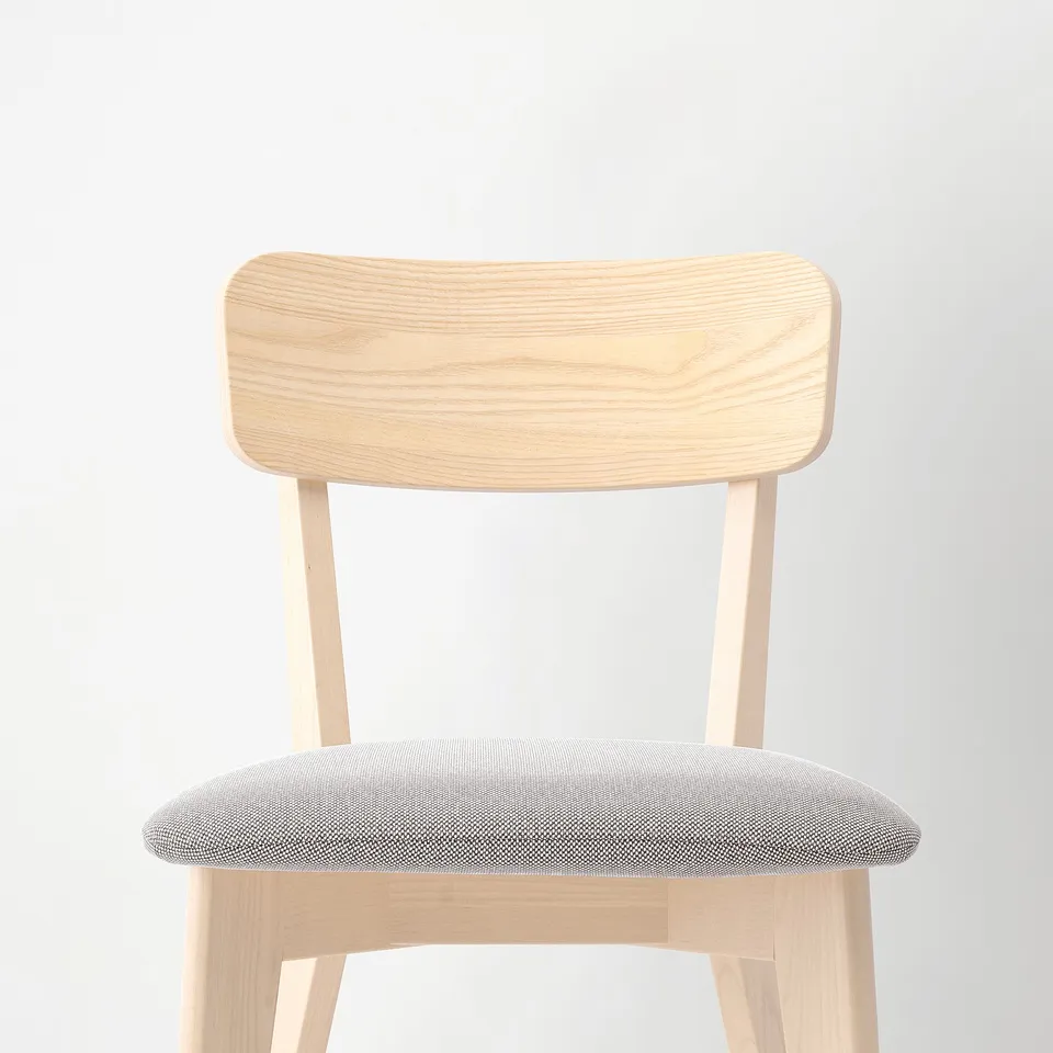 A modern chair with a curved wooden back and cushioned seat. Quality materials ensure durability and comfort.